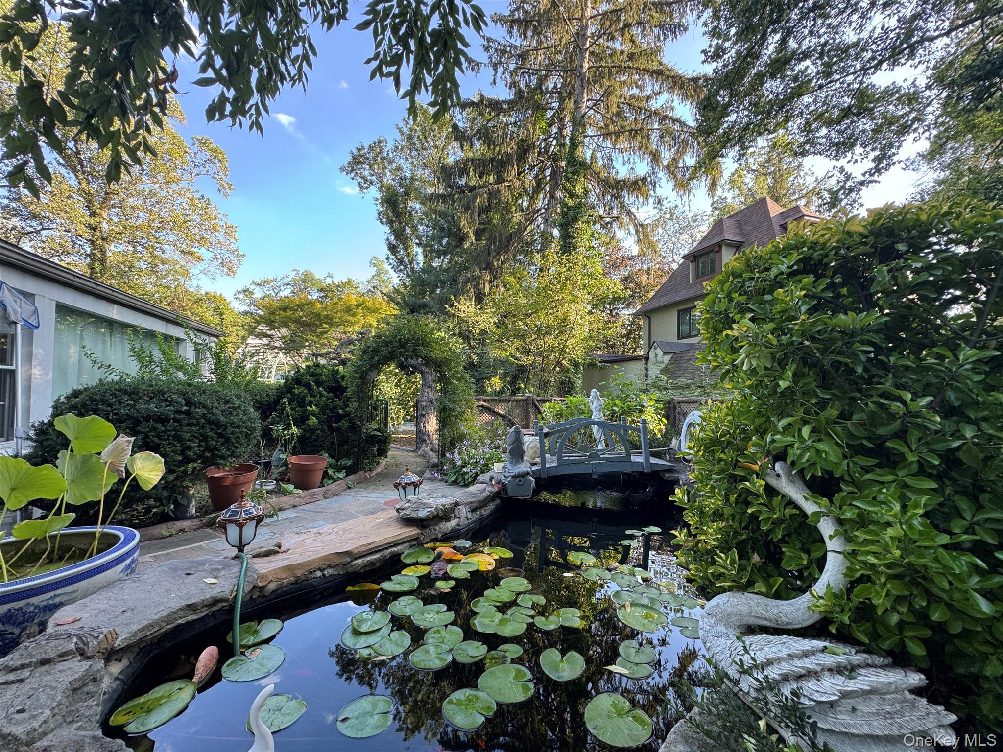 16 Ascot Ridge Great Neck, NY 11021 - Photo 4 of 23 View of yard featuring a small pond
