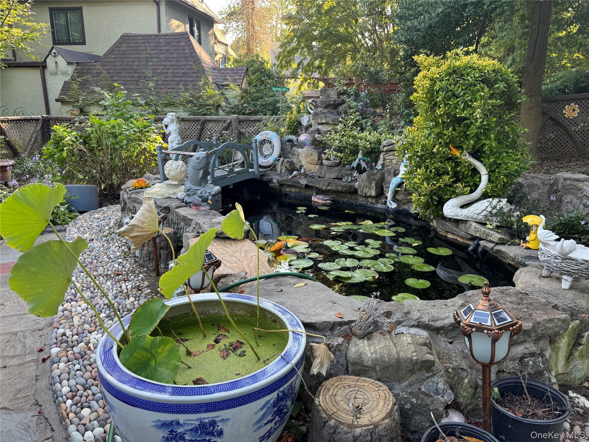 16 Ascot Ridge Great Neck, NY 11021 - Photo 5 of 23 View of yard featuring a garden pond
