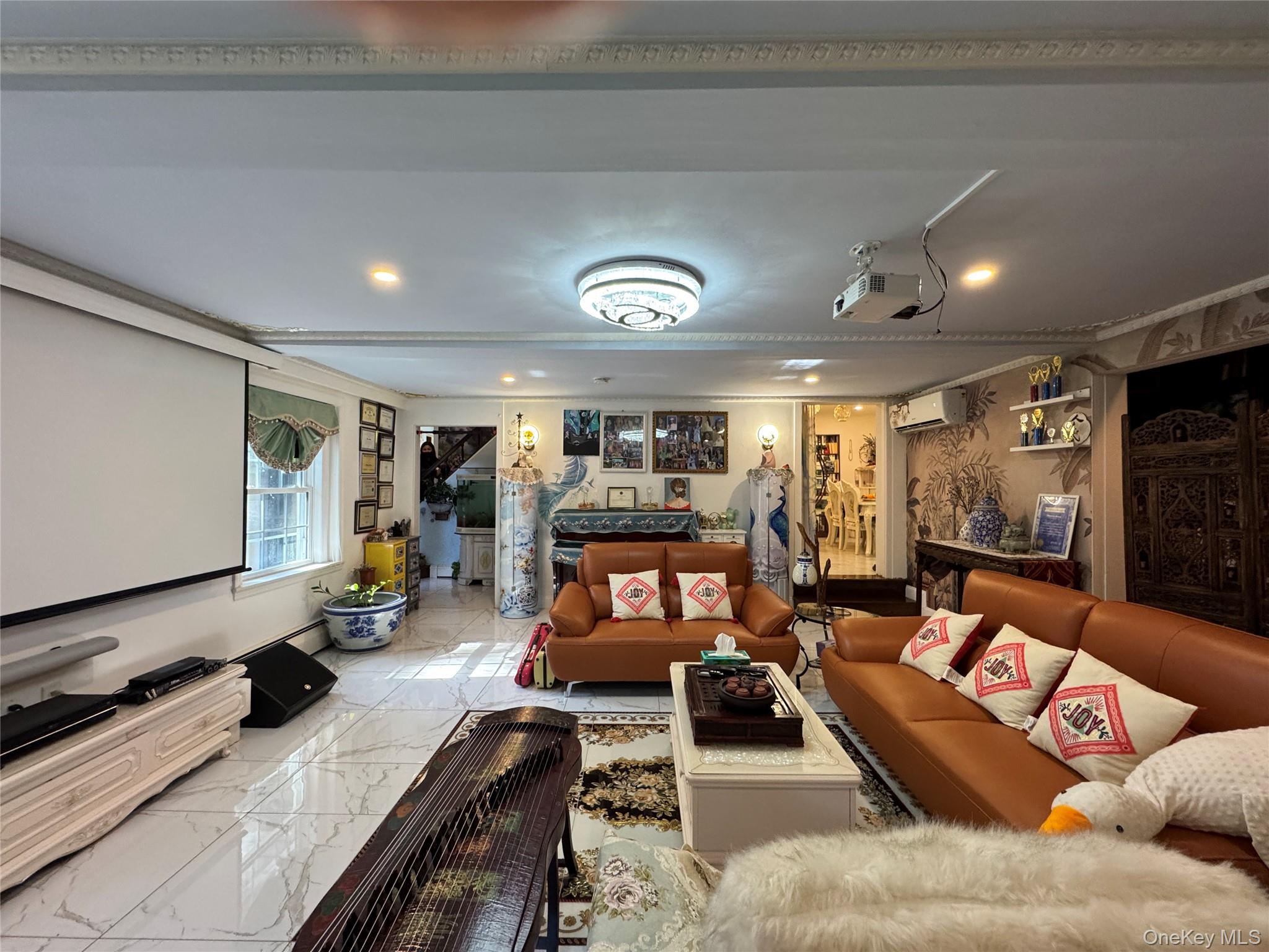 16 Ascot Ridge Great Neck, NY 11021 - Photo 8 of 23 Home theater featuring marble finish flooring, crown molding, and recessed lighting