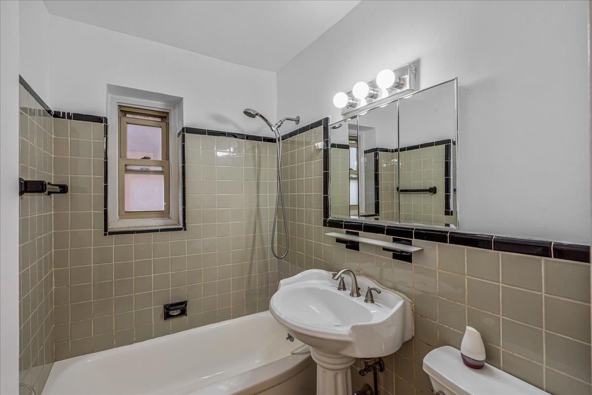144-55 Melbourne Avenue, Unit 2F Queens, NY 11367 - Photo 14 of 21 a bathroom with a sink mirror and tub