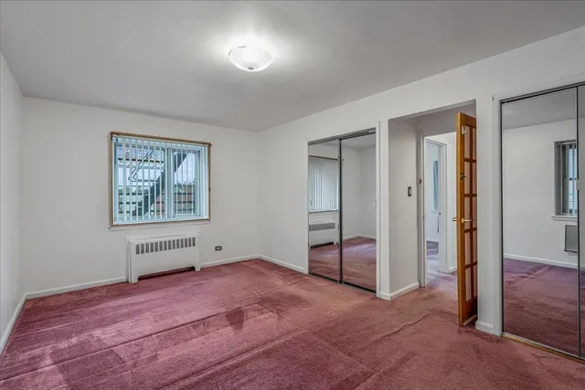 a view of empty room with window and ceiling fan