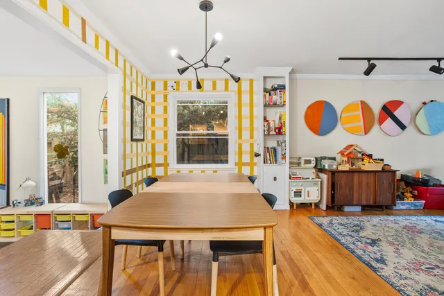 a view of a dining room with furniture and chandelier