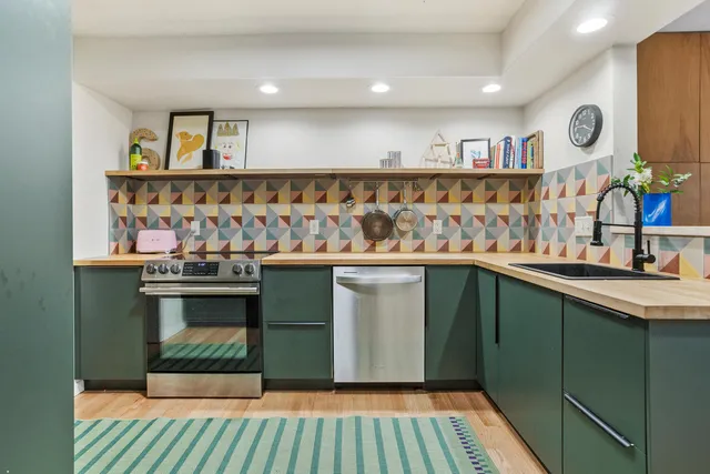 a kitchen with stainless steel appliances granite countertop a refrigerator and a sink