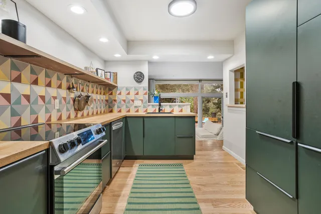 a kitchen with stainless steel appliances lots of counter top space and cabinets