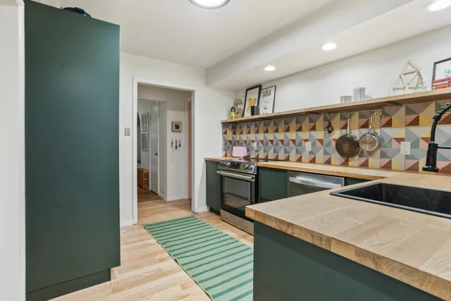 a kitchen with a refrigerator and a sink