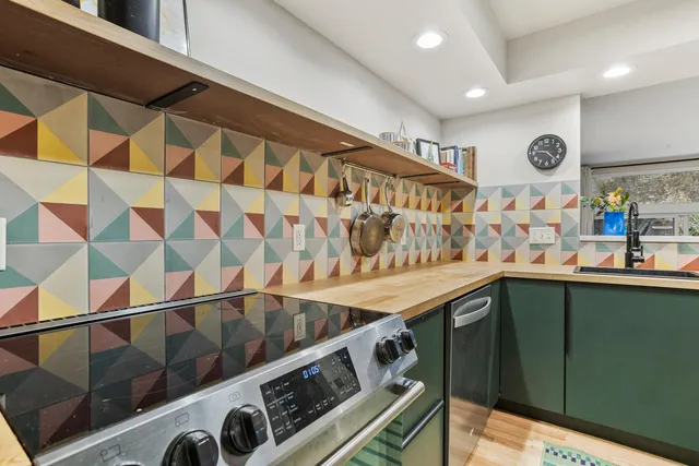 a kitchen with stainless steel appliances granite countertop a sink and cabinets