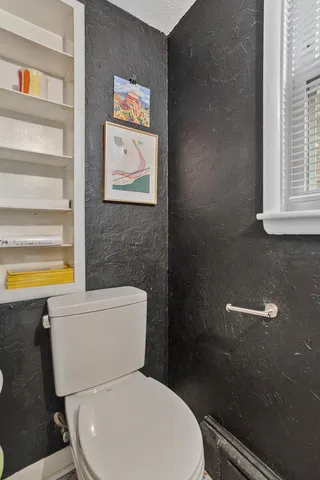 a white toilet sitting next to a bathroom sink