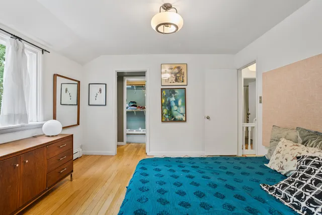 a bedroom with a bed and a large window