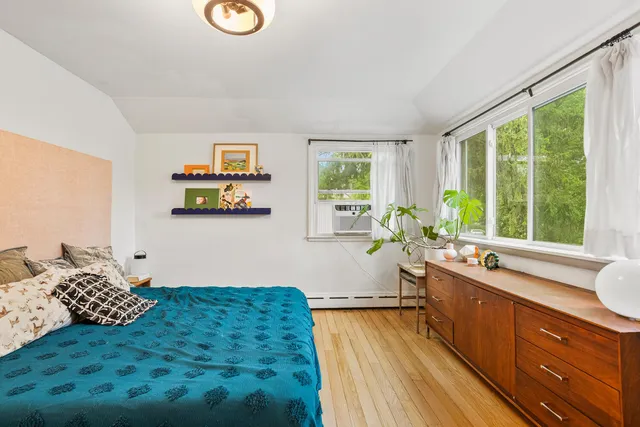 a view of a kitchen with wooden floor and white walls