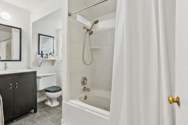 a view of backyard with large trees and wooden fence