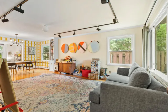 a living room with furniture and a floor to ceiling window