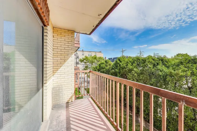a balcony with view of an outdoor space