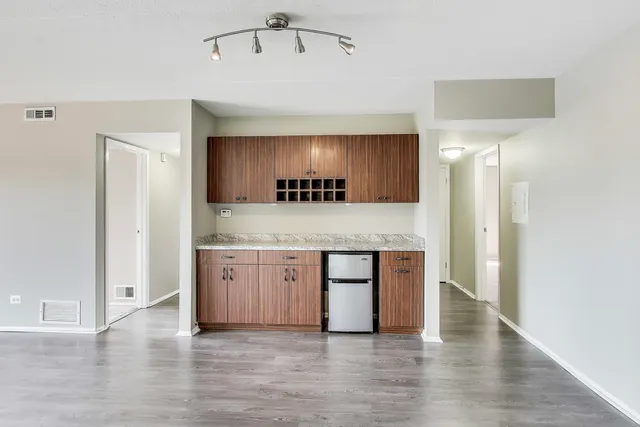 a view of empty room with wooden floor and ceiling fan