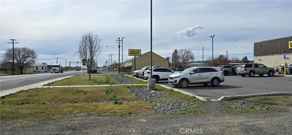 a view of a street with cars parked