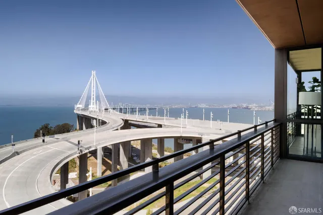 a view of a balcony with furniture and wooden floor