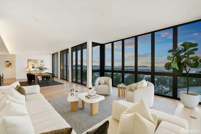 a living room with furniture a mirror and a fireplace