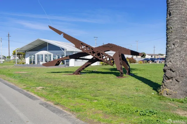 a outdoor sitting space with couch and chairs