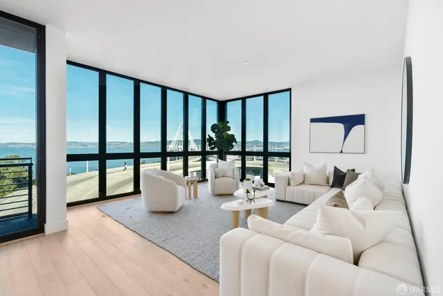 a large bed sitting in a bedroom next to a lamp