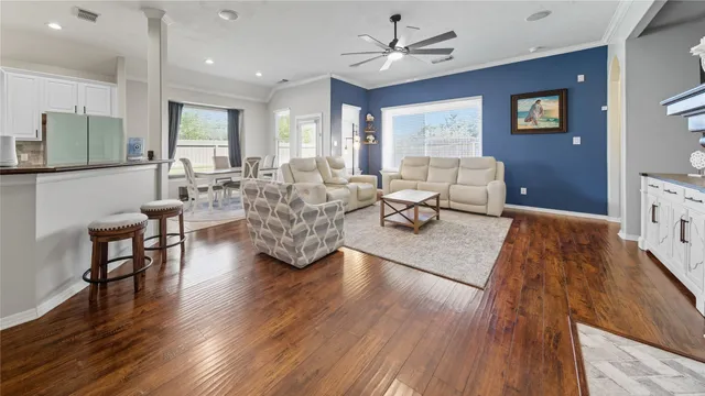a living room with furniture and a wooden floor