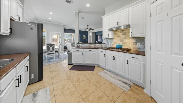 a kitchen with stainless steel appliances granite countertop a sink and cabinets