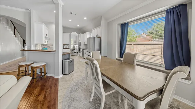 a dining room with furniture and a large window