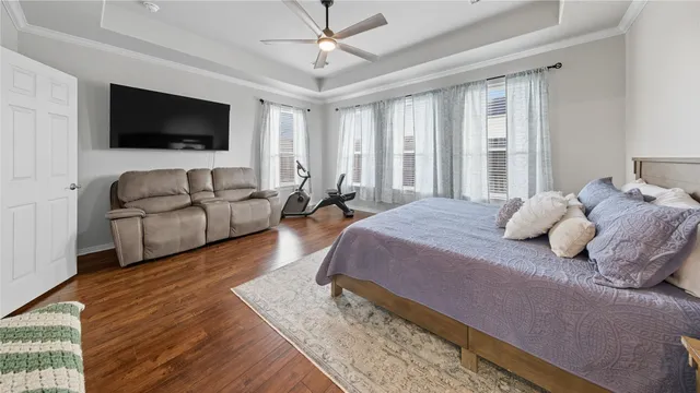 a bedroom with a large bed and a flat screen tv