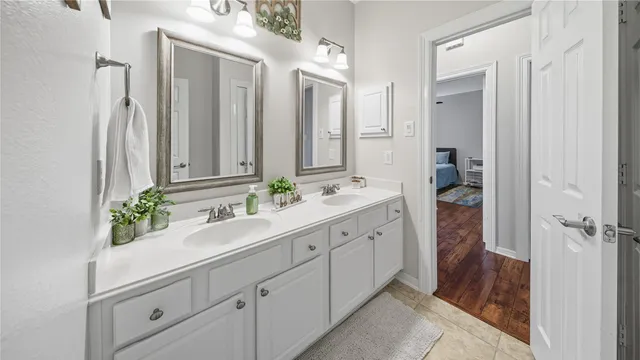 a bathroom with a double vanity sink and mirror