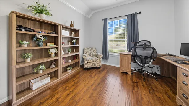 a view of a workspace with furniture and wooden floor