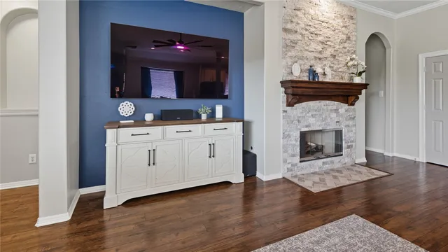 a living room with a fireplace and wooden floor