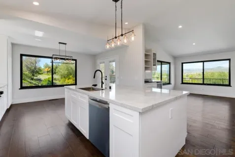 a kitchen with sink stove and refrigerator