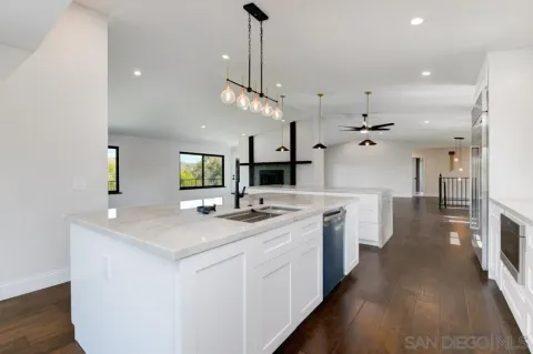 a kitchen with stainless steel appliances a sink stove and cabinets