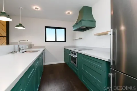 a bathroom with a granite countertop sink and a washing machine
