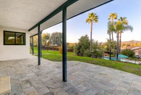 a view of a house with a backyard