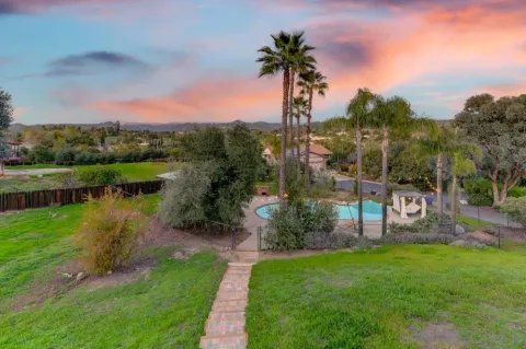 a view of a chairs and table in backyard