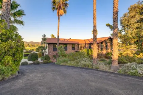 a view of a patio with table and chairs potted plants