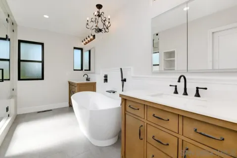 a spacious bathroom with a sink a toilet and mirror