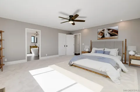 a bedroom with a large bed and ceiling fan