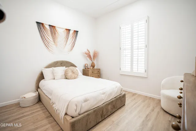 a bedroom with a bed and a window