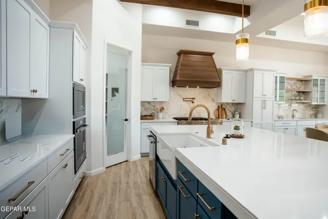 a kitchen with sink a stove and refrigerator