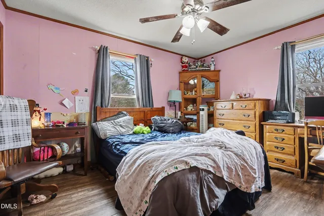 a bedroom with a bed and flat screen tv