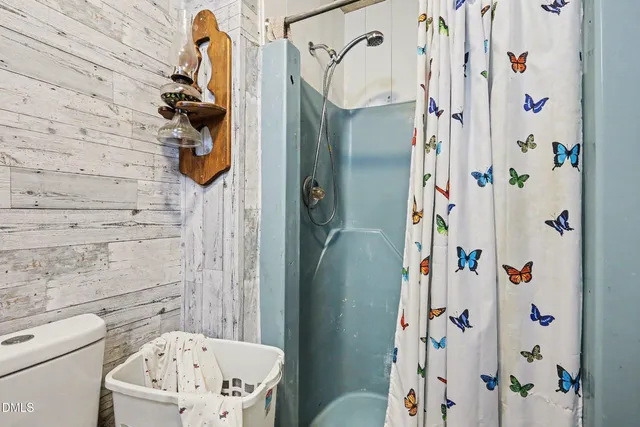 a view of a house with a wooden fence