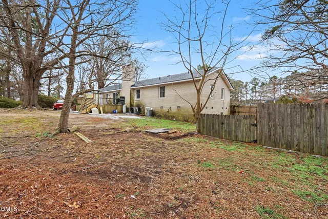 a view of a house with backyard and sitting area