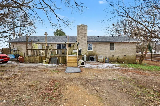 a view of a yard with a house and a large tree