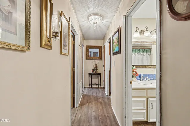 a view of a hallway with wooden floor and entryway