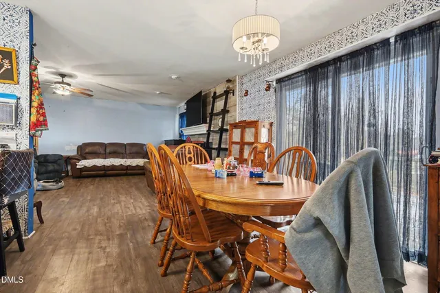 a dining room with furniture and wooden floor
