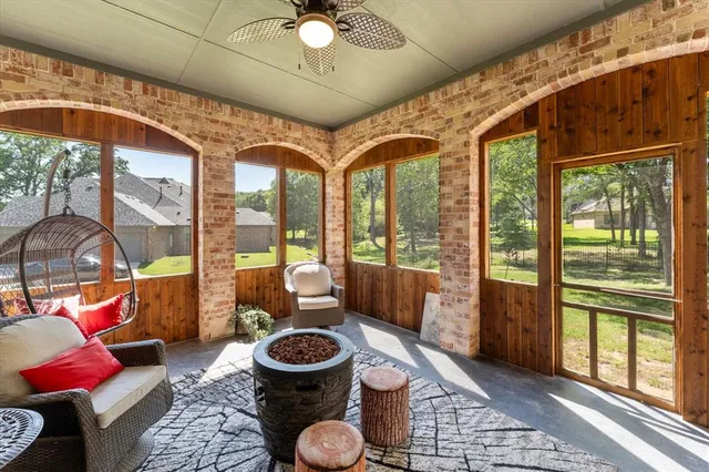 a living room with furniture and a floor to ceiling window