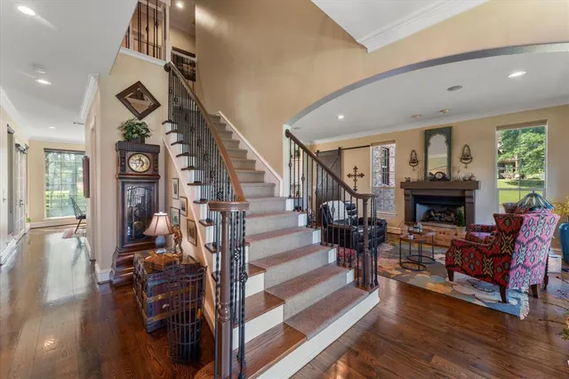 a living room with fireplace furniture and a wooden floor