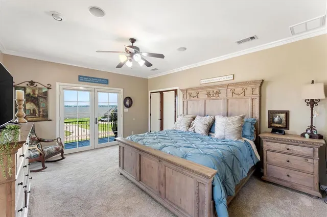 a bedroom with a bed and large windows