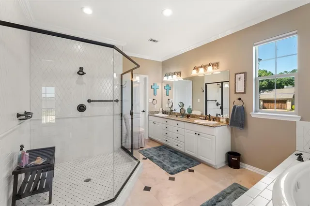 a bathroom with a double vanity sink toilet and shower