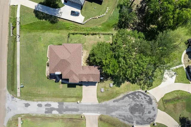 an aerial view of a house with a yard basket ball court and outdoor seating